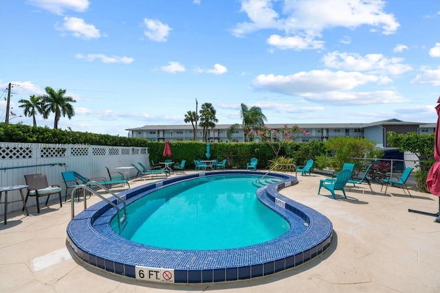 view of swimming pool with a patio