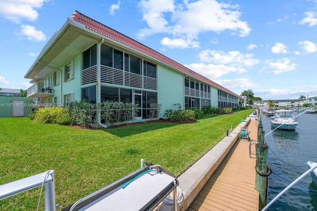 exterior space featuring a lawn and a water view