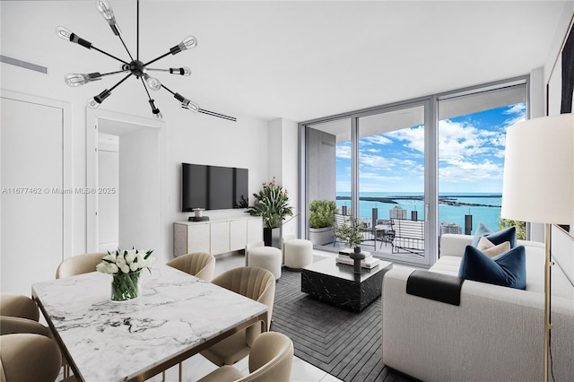 living room with floor to ceiling windows and visible vents