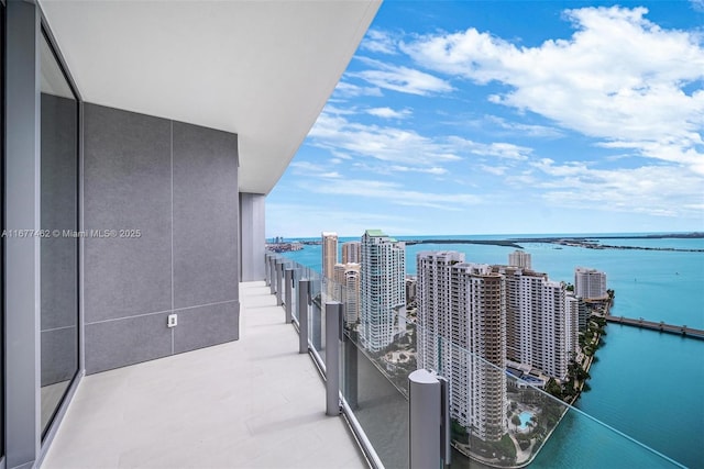 balcony with a water view and a city view