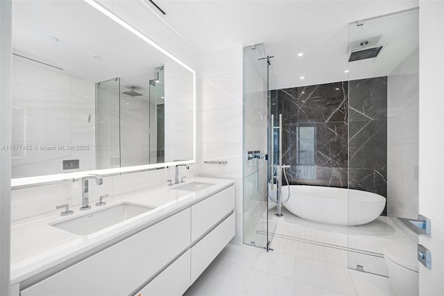 full bathroom featuring double vanity, a sink, and walk in shower