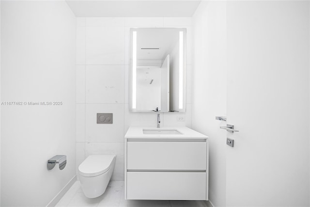 bathroom featuring marble finish floor, vanity, and toilet