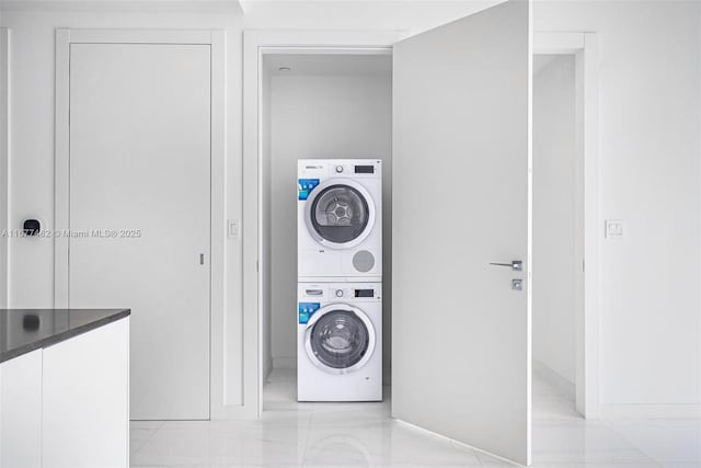 clothes washing area featuring laundry area and stacked washing maching and dryer