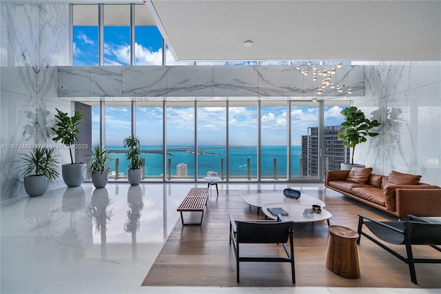 interior space featuring a water view, a wealth of natural light, and floor to ceiling windows