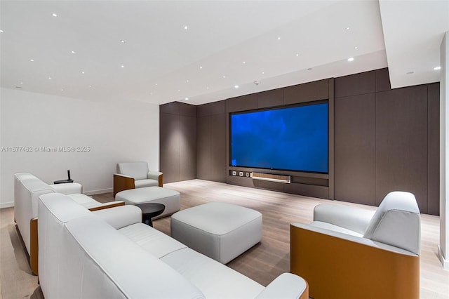 home theater featuring light wood finished floors and recessed lighting