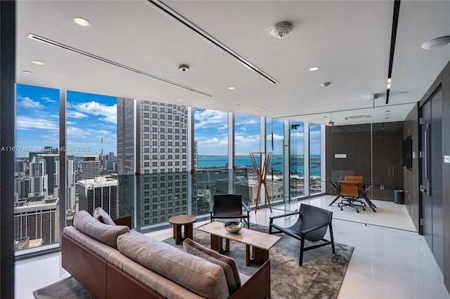 living area featuring floor to ceiling windows, a city view, and recessed lighting