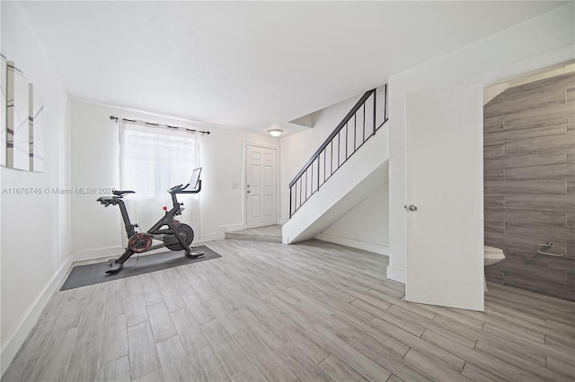 workout room with light hardwood / wood-style flooring