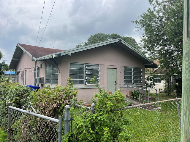 bungalow-style house featuring cooling unit