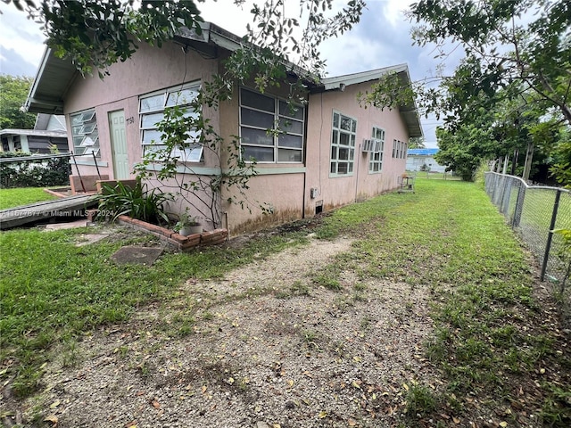 view of side of home with a lawn