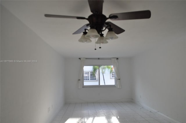 tiled empty room with ceiling fan