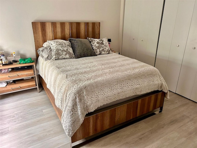 bedroom featuring a closet and light hardwood / wood-style flooring