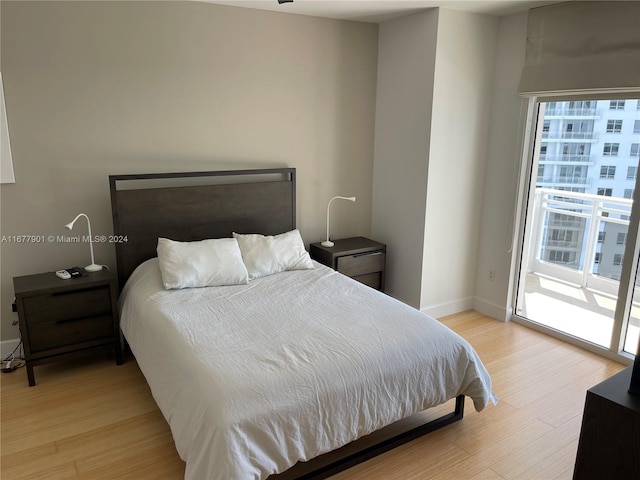 bedroom with light hardwood / wood-style flooring, multiple windows, and access to exterior