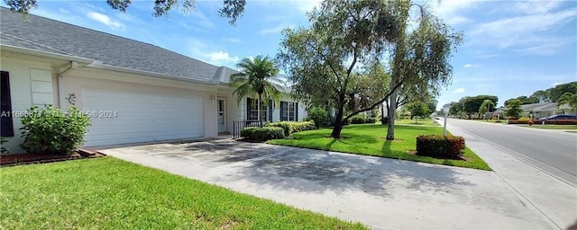 view of front of house featuring a front yard and a garage