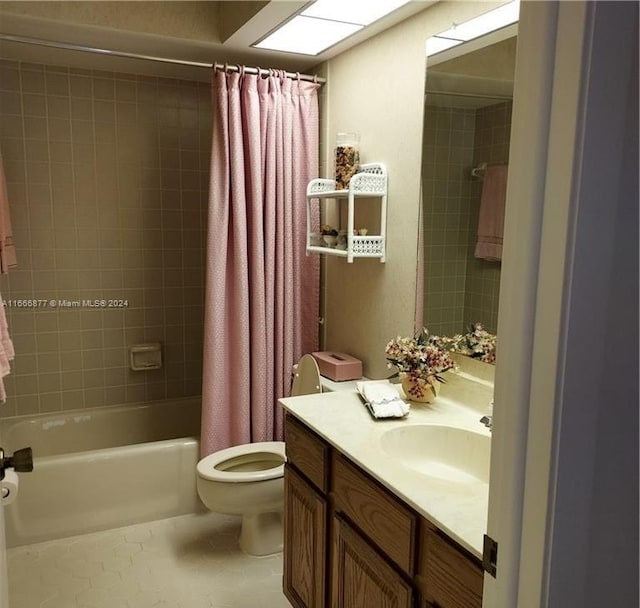 full bathroom with vanity, toilet, tile patterned flooring, and shower / tub combo with curtain