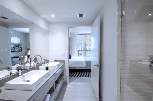 bathroom with vanity and tiled shower