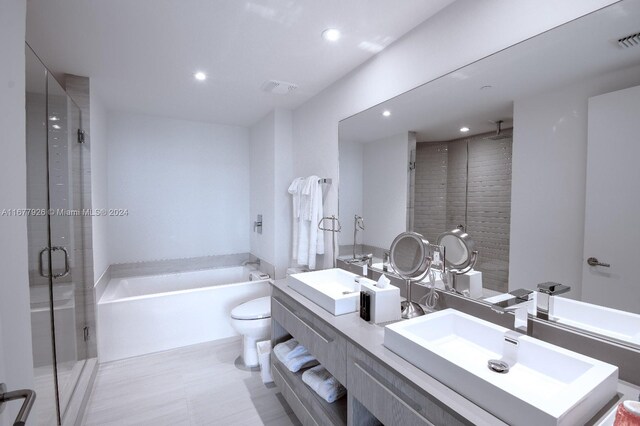 full bathroom with vanity, shower with separate bathtub, and toilet