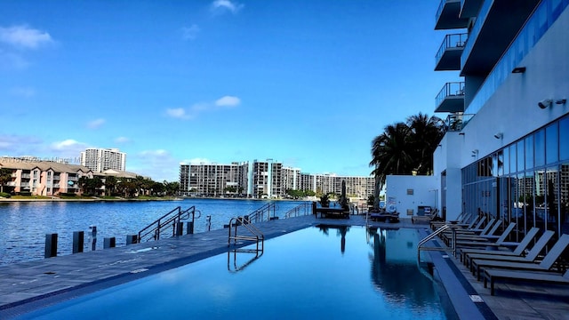 view of swimming pool with a water view