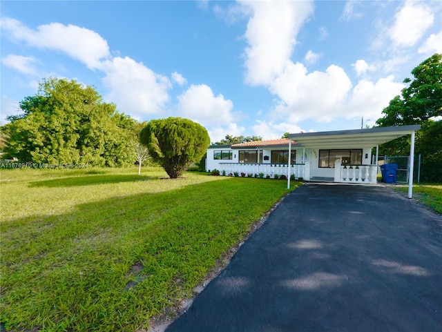 single story home featuring a front lawn and a carport