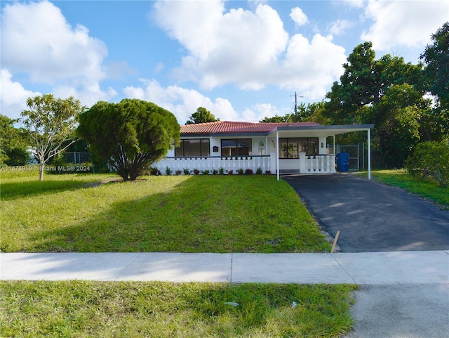 single story home with a front lawn and a carport