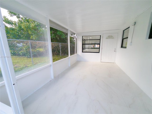 unfurnished sunroom with lofted ceiling