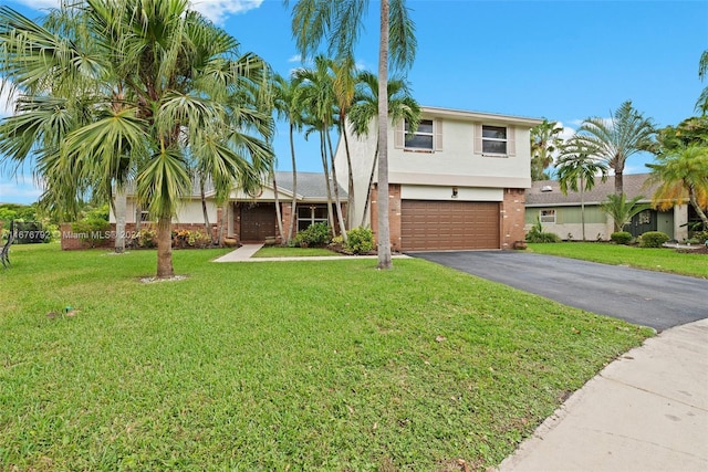 view of front of house with a front yard and a garage