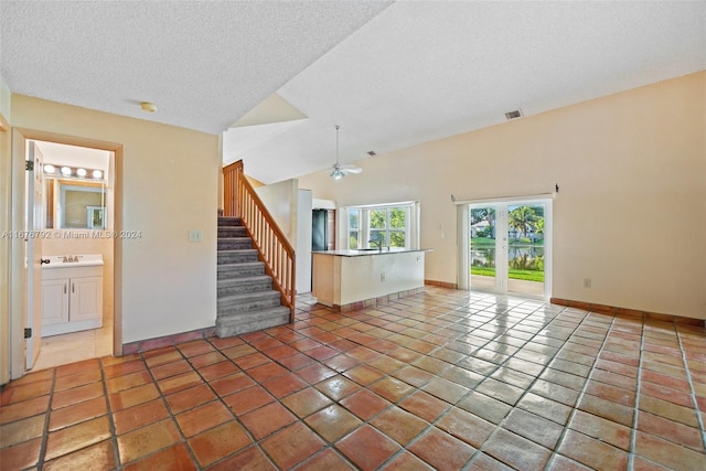 tiled empty room with sink, a textured ceiling, and ceiling fan