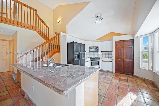 kitchen featuring white cabinetry, light stone countertops, black appliances, and sink