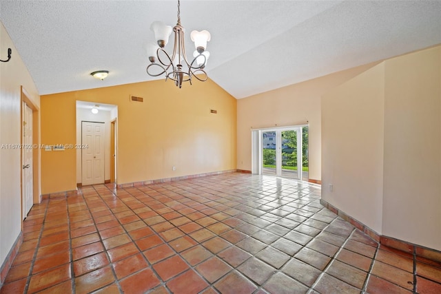 tiled empty room with an inviting chandelier, a textured ceiling, and high vaulted ceiling