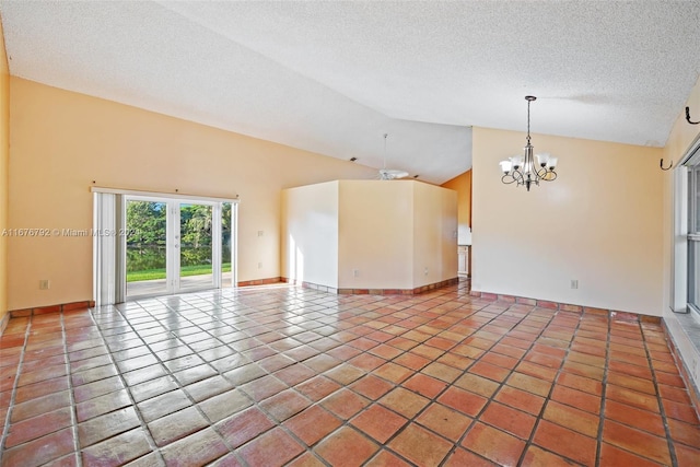 tiled spare room with a chandelier, a textured ceiling, and high vaulted ceiling