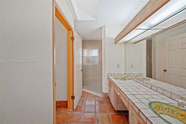 bathroom featuring vanity and tiled shower