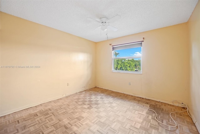 unfurnished room with light parquet floors, a textured ceiling, and ceiling fan