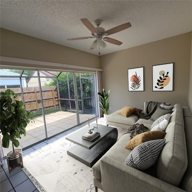 living room with a textured ceiling and ceiling fan