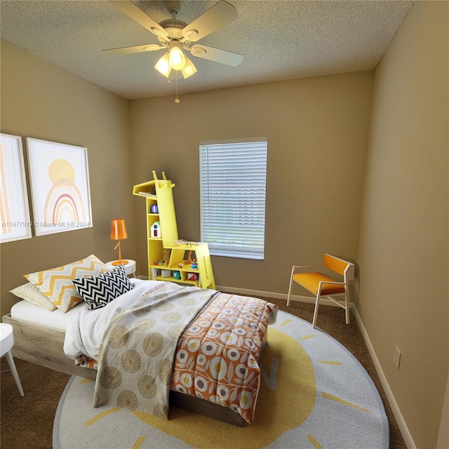 bedroom featuring carpet flooring, a textured ceiling, and ceiling fan