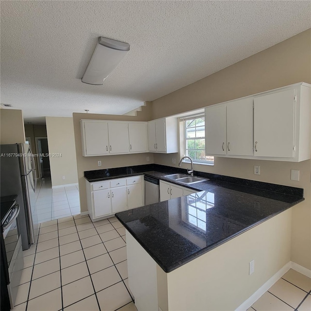 kitchen with white cabinets, kitchen peninsula, and sink