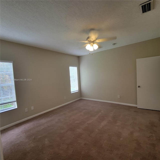 carpeted empty room with a textured ceiling and ceiling fan