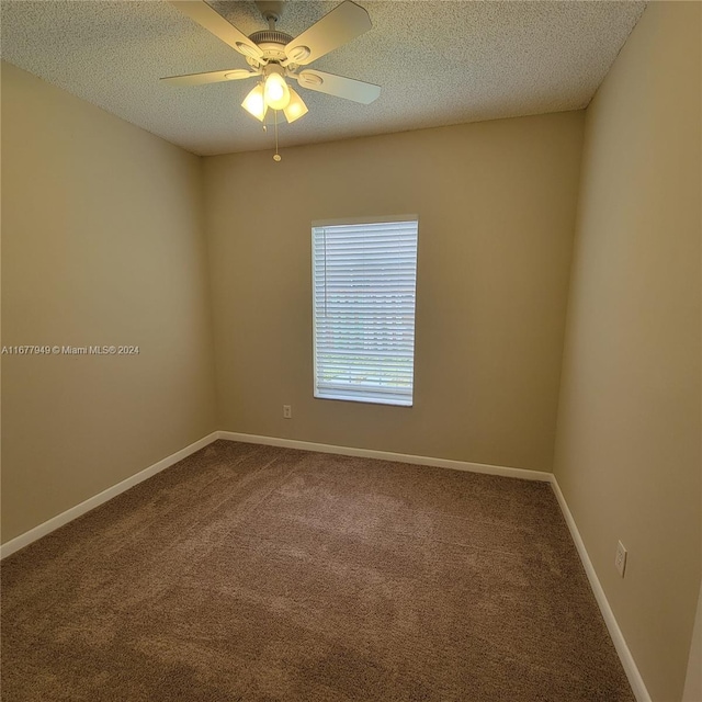 spare room featuring ceiling fan, a textured ceiling, and carpet floors