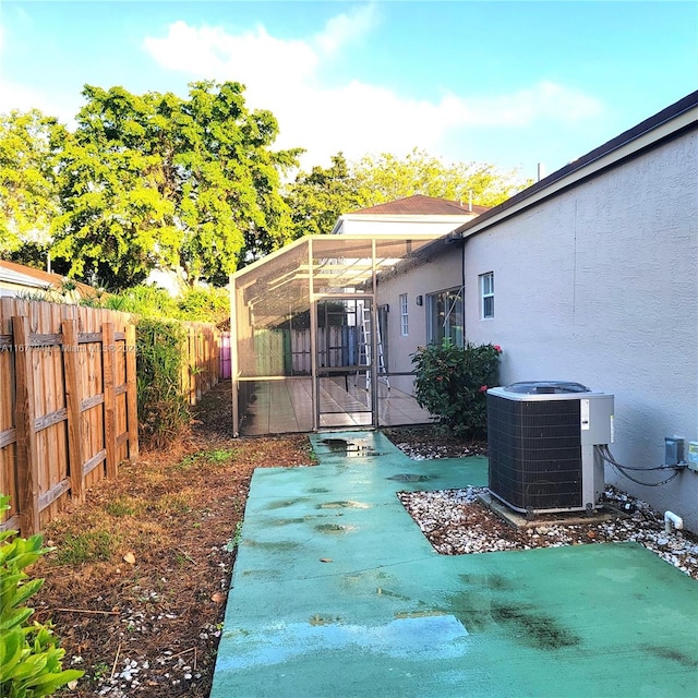 view of patio / terrace featuring a sunroom and cooling unit