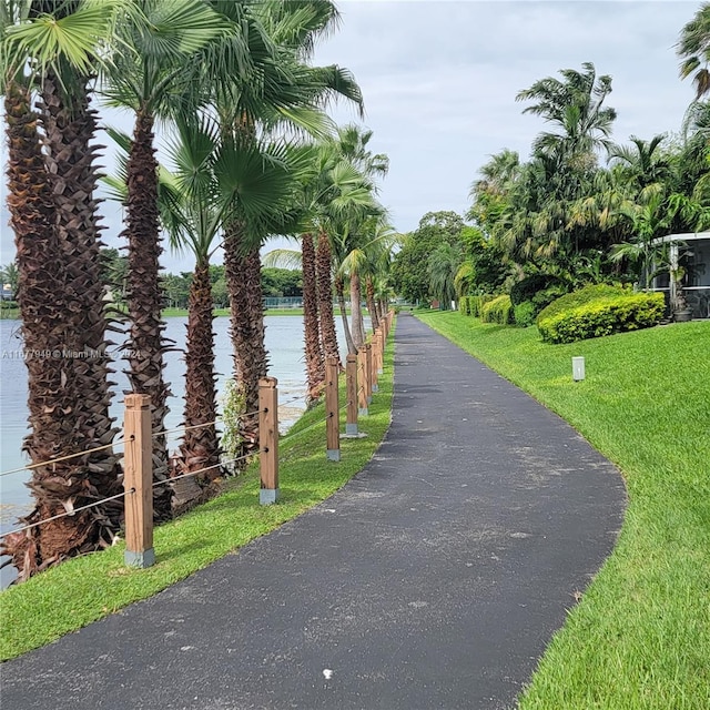 view of community featuring a lawn and a water view