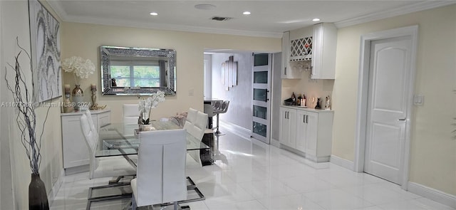 interior space with ornamental molding and light tile patterned floors