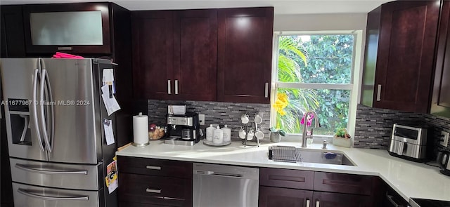 kitchen featuring sink, appliances with stainless steel finishes, and tasteful backsplash