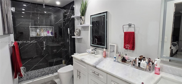 bathroom featuring vanity, toilet, and a shower with door