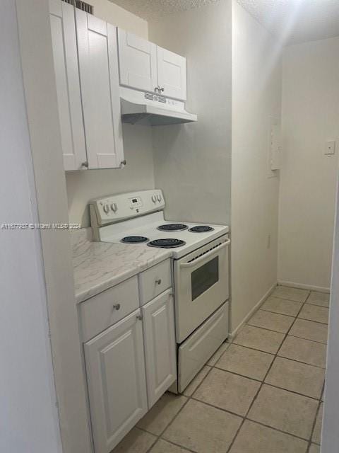1068NBENOIST Farm Rd Unit 105, West Palm Beach, FL 33411 - kitchen with white electric range, under cabinet range hood, white cabinets, light tile patterned floors, and a textured ceiling
