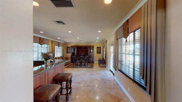 1068NBENOIST Farm Rd Unit 105, West Palm Beach, FL 33411 - kitchen featuring ornamental molding, recessed lighting, baseboards, brown cabinetry, and light tile patterned floors