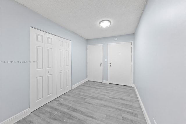 interior space featuring light hardwood / wood-style floors and a textured ceiling