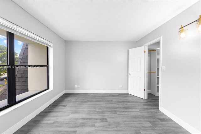 empty room with hardwood / wood-style floors