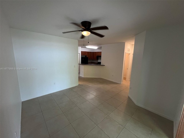 unfurnished room featuring light tile patterned floors and ceiling fan