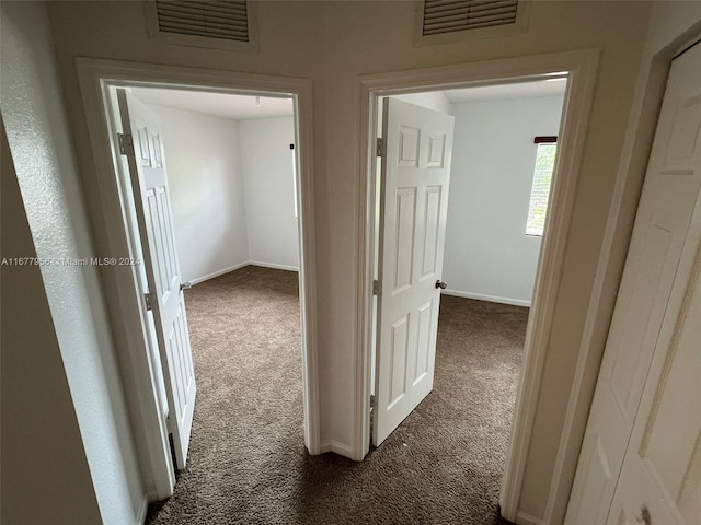 hallway with dark carpet