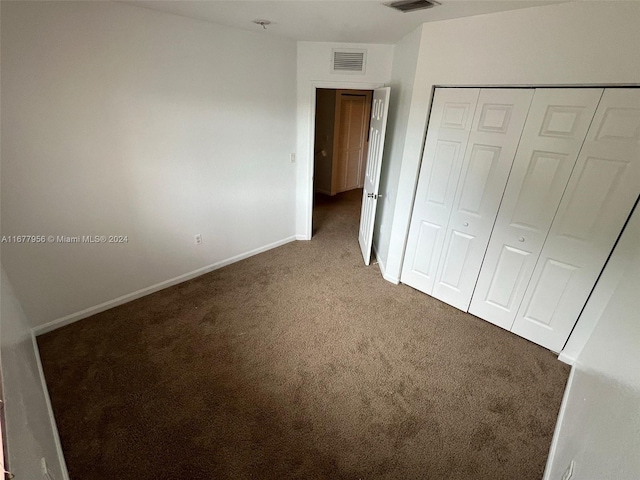 unfurnished bedroom with carpet floors and a closet