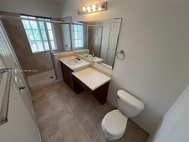 bathroom featuring vanity, toilet, and an enclosed shower