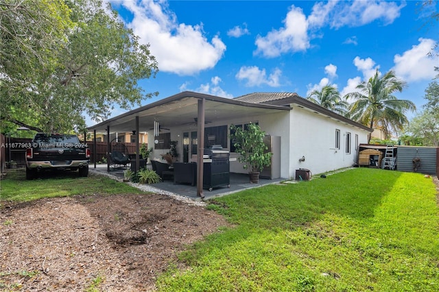 rear view of house with a patio area and a lawn